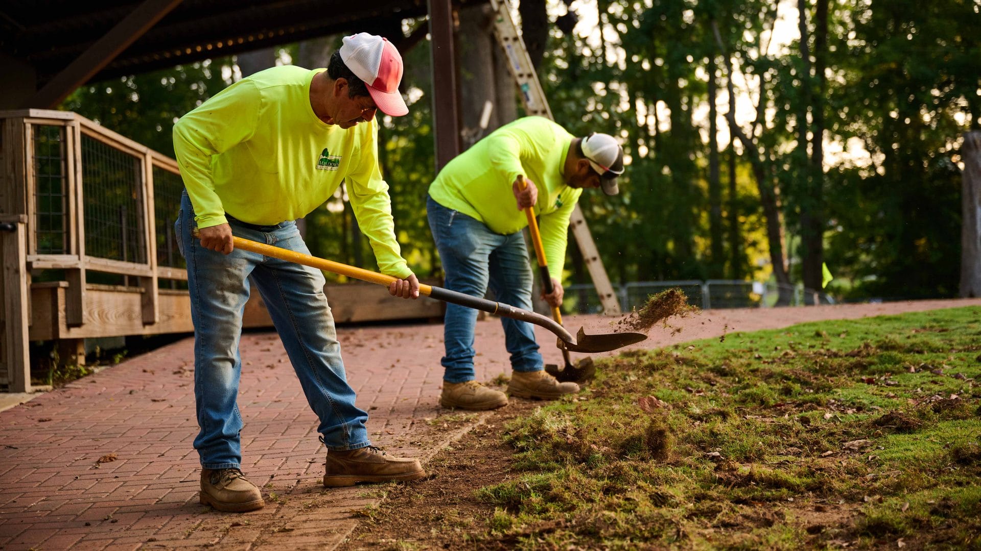 Two men working on freshly laid lawn